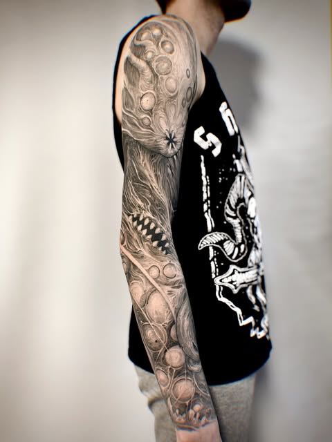 Bio-organic black and grey full sleeve tattoo