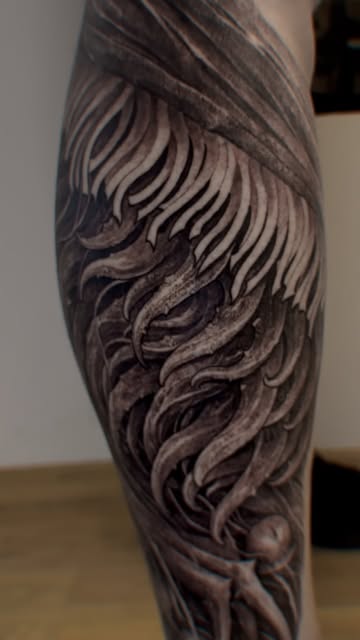 Flowing freehand organic tattoo on a lower leg